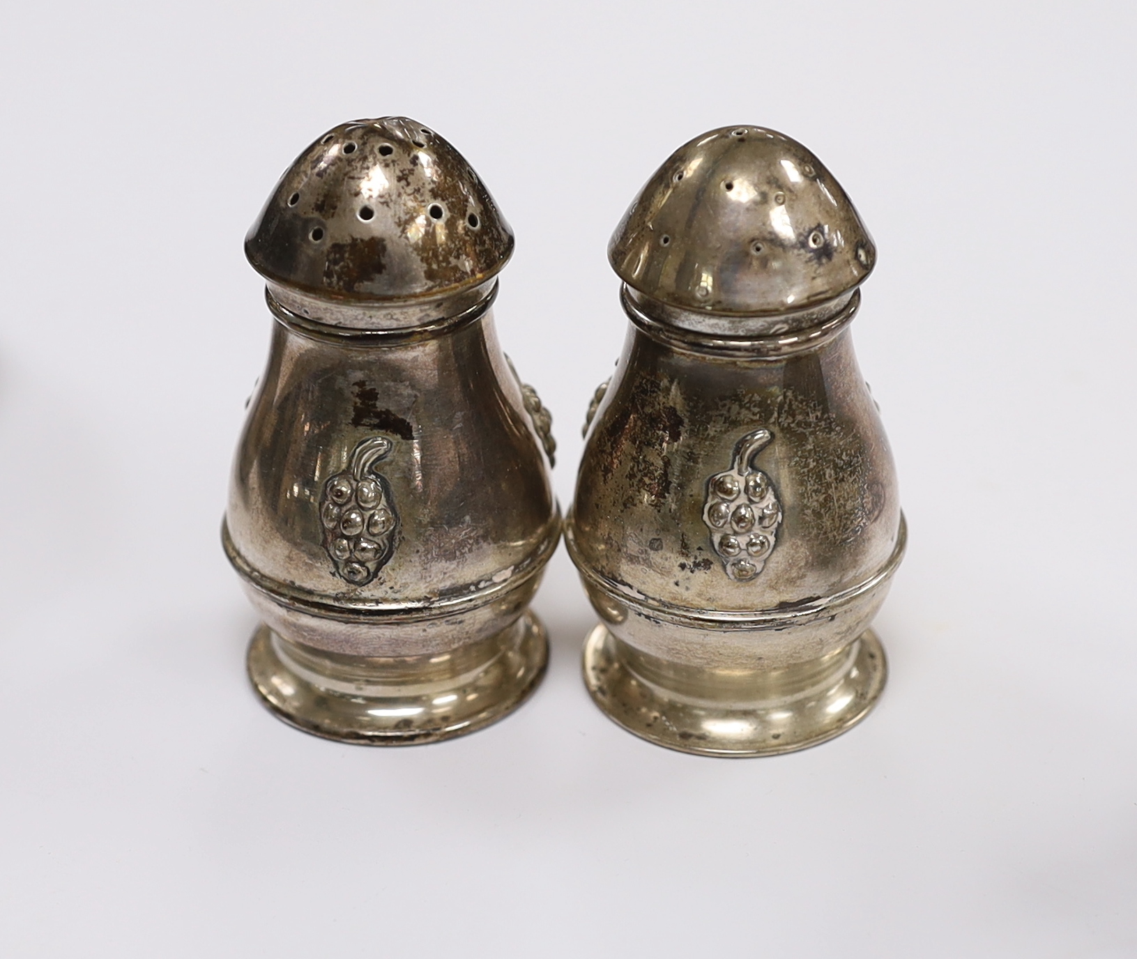 A Danish 830 white metal sifter spoon and tea strainer, by Evald Nielsen and a pair of 1930's Danish white metal condiments.